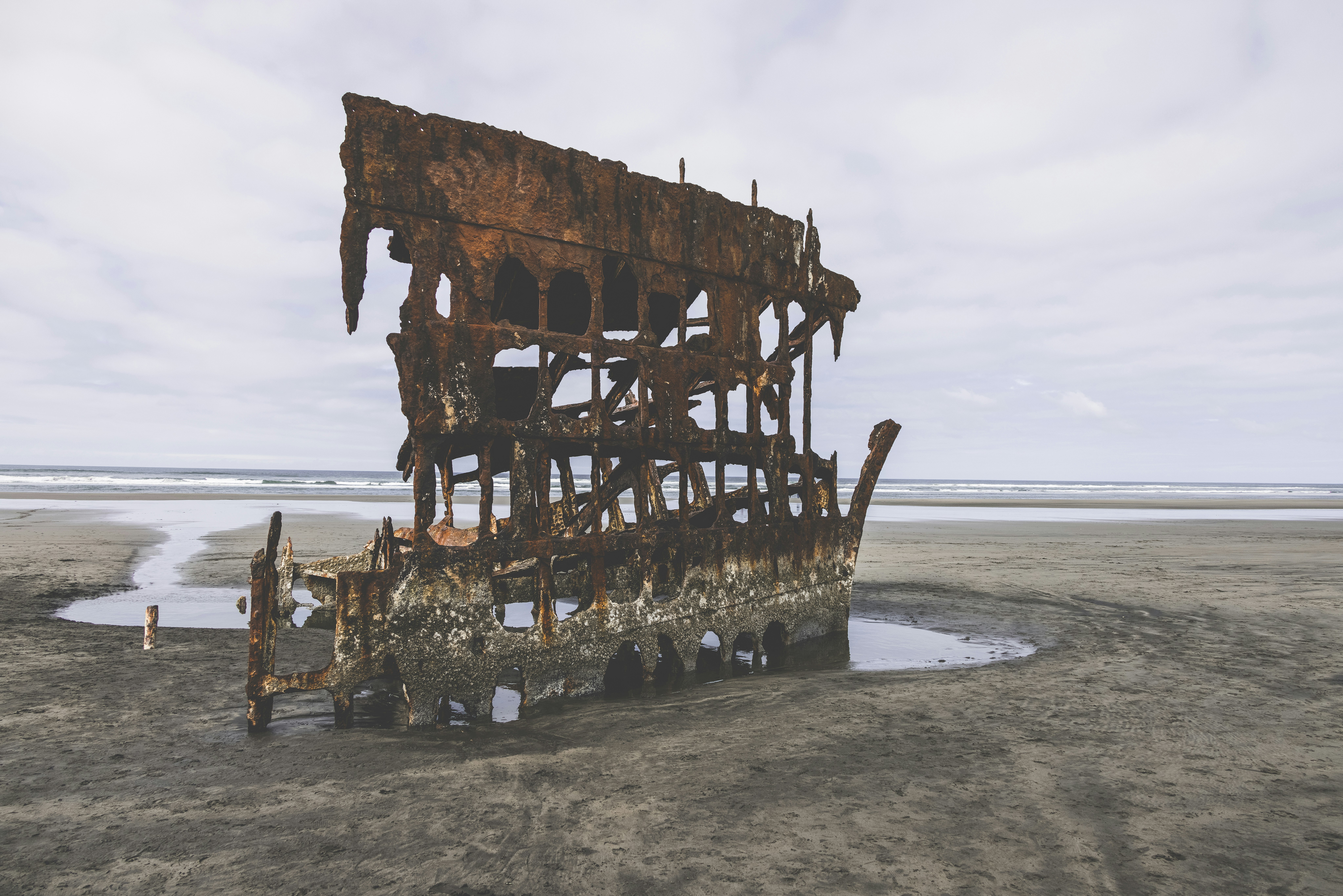 brown wooden ship on sea shore during daytime